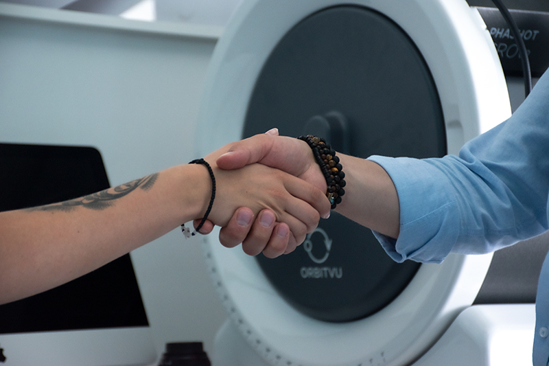 Handshake of a photographer and a model in a studio