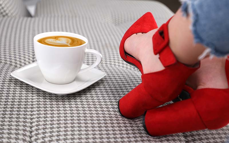 A shofie with cappuccino and red shoes