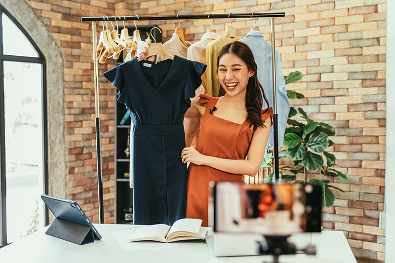 smiling girl holding dress